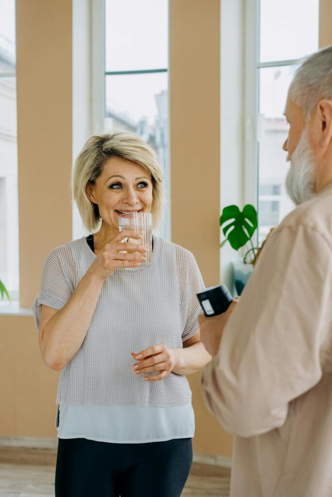 a woman drinking a glass of water